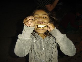 09-Shivani enjoys a yummy s'more at the beach bonfire