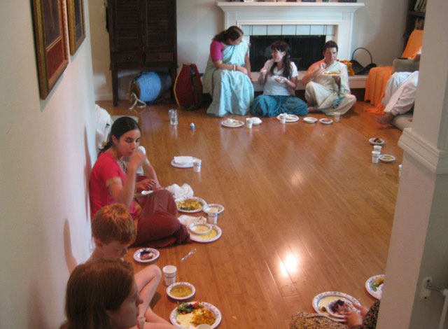 12-All the devotees and their guests contentedly honoring prasad